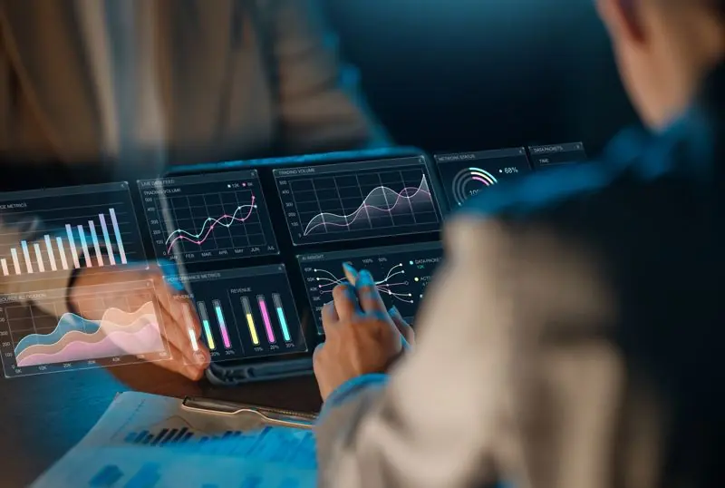 Operations manager viewing a custom job-tracking dashboard on a monitor