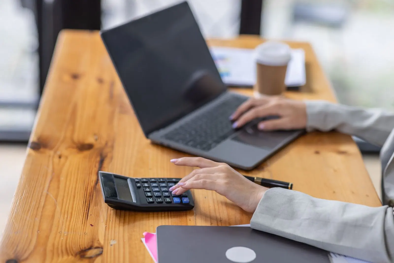 Three price tags beside laptops showing a simple, a mid-range and a complex website design