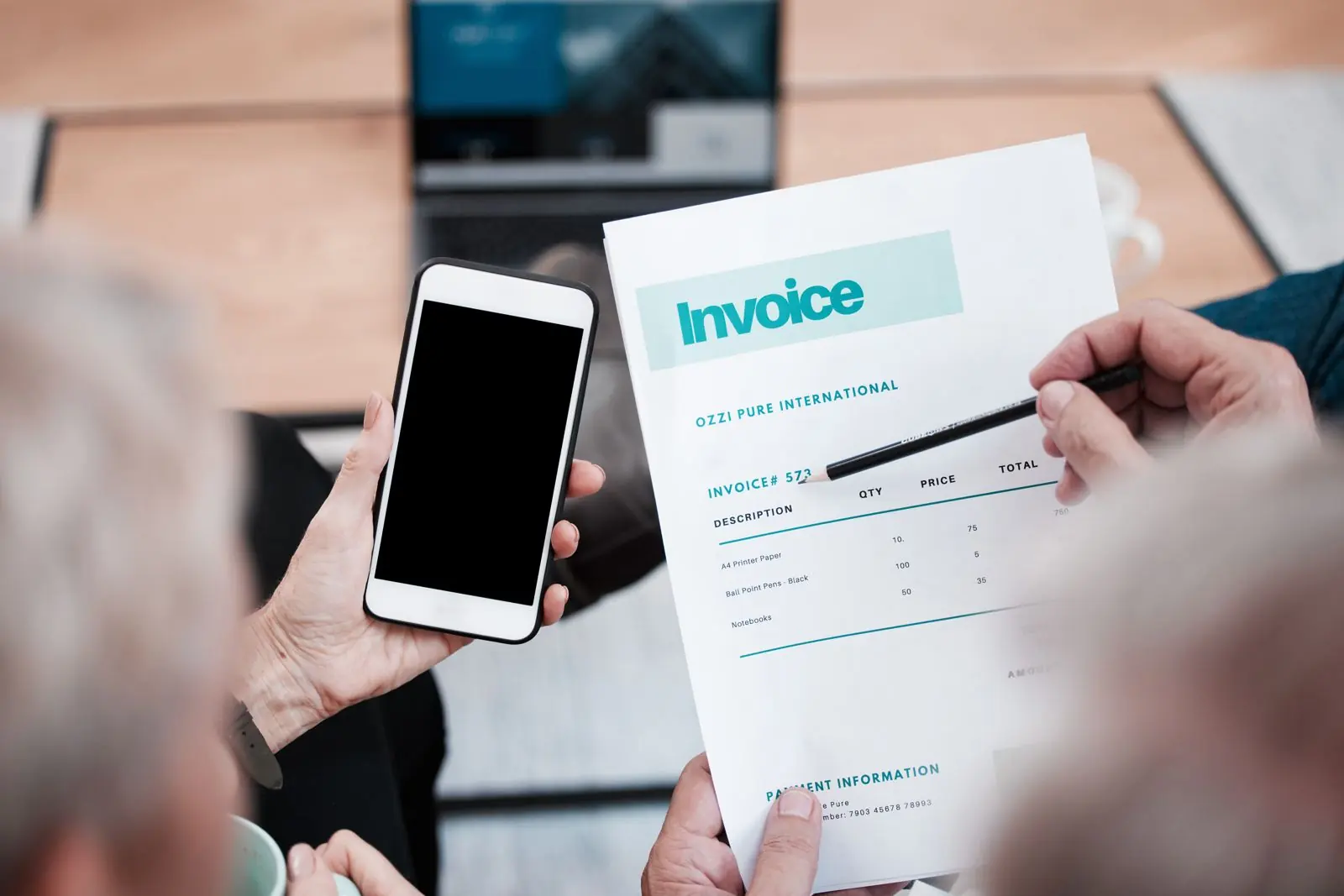 Printed website design quote with itemised costs, a pen and a coffee cup on a desk